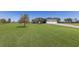 Well-maintained home featuring a spacious three-car garage and lush green lawn at 4606 Lake Fox Pl, Parrish, FL 34219