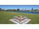 Inviting backyard with a stone fire pit, perfect for cozy evenings by the pond at 4606 Lake Fox Pl, Parrish, FL 34219