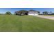 Expansive front lawn leading to a home with a two-car garage and well-manicured landscaping at 4606 Lake Fox Pl, Parrish, FL 34219