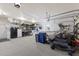 Well-organized garage with a boat, lawnmower, and shelving, providing ample storage and workspace at 4606 Lake Fox Pl, Parrish, FL 34219
