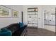 Stylish hallway featuring a comfortable sofa, hardwood floors, and decorative shelving with accents at 4606 Lake Fox Pl, Parrish, FL 34219