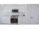 Bright kitchen featuring white cabinets, stainless steel appliances, and granite countertops at 4606 Lake Fox Pl, Parrish, FL 34219