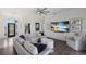 Open-concept living room featuring a large TV, modern decor, and lots of natural light at 4606 Lake Fox Pl, Parrish, FL 34219