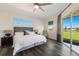 Main bedroom with luxury vinyl floors, slider to backyard and tranquil outdoor view at 4606 Lake Fox Pl, Parrish, FL 34219