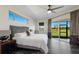 Main bedroom with luxury vinyl floors, slider to backyard and tranquil outdoor view at 4606 Lake Fox Pl, Parrish, FL 34219