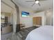 Main bedroom with luxury vinyl floors, slider to outdoor living space overlooking a covered porch at 4606 Lake Fox Pl, Parrish, FL 34219