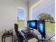 Bright office space showcasing a modern desk setup with dual monitors and a scenic view at 4606 Lake Fox Pl, Parrish, FL 34219