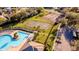 Aerial view showcasing a pool, tennis and basketball courts, parking, and landscaped common area at 4706 Cayo Costa Pl, Bradenton, FL 34203