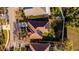 Aerial view of a single-Gathering home featuring solar panels, a fire pit, a trampoline and lush green yard at 4706 Cayo Costa Pl, Bradenton, FL 34203