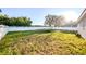 Expansive backyard with lush lawn, bordered by a white picket fence, and some playground equipment for outdoor enjoyment at 4706 Cayo Costa Pl, Bradenton, FL 34203