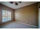 Bedroom featuring gray carpet and a large window with blinds for natural light at 4706 Cayo Costa Pl, Bradenton, FL 34203