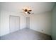 Bedroom with neutral carpet, ceiling fan, closet and door at 4706 Cayo Costa Pl, Bradenton, FL 34203