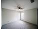 Spacious bedroom featuring a ceiling fan, neutral paint, carpet, and natural light from a window at 4706 Cayo Costa Pl, Bradenton, FL 34203
