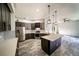 Spacious kitchen with an island, stainless steel appliances, modern cabinets, and stylish pendant lighting at 4706 Cayo Costa Pl, Bradenton, FL 34203