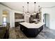 Bright kitchen features an oversized island with quartz countertops, stainless appliances, and dark wood cabinets at 4706 Cayo Costa Pl, Bradenton, FL 34203