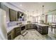 Modern kitchen featuring stainless steel appliances, gray cabinetry, white countertops, and pendant lighting at 4706 Cayo Costa Pl, Bradenton, FL 34203
