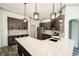 Modern kitchen with gray cabinets, quartz countertops, a large island, and stainless steel appliances at 4706 Cayo Costa Pl, Bradenton, FL 34203