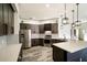Updated kitchen with stainless steel refrigerator, tile backsplash, quartz countertops, and wood-look floors at 4706 Cayo Costa Pl, Bradenton, FL 34203