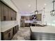 Modern kitchen featuring stainless steel appliances, gray cabinetry, white countertops, and pendant lighting at 4706 Cayo Costa Pl, Bradenton, FL 34203