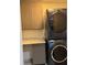 Laundry room featuring stacked washer and dryer units, cabinets, and a countertop at 4706 Cayo Costa Pl, Bradenton, FL 34203