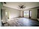Bright living room featuring stylish wood-look tile floors and a modern ceiling fan at 4706 Cayo Costa Pl, Bradenton, FL 34203