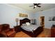 Primary bedroom with hardwood floors, ceiling fan and ensuite bath at 4706 Cayo Costa Pl, Bradenton, FL 34203