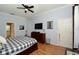 Primary bedroom with hardwood floors, ceiling fan and ensuite bath at 4706 Cayo Costa Pl, Bradenton, FL 34203