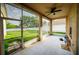 Screened patio with ceiling fan and a view of the spacious fenced backyard at 4706 Cayo Costa Pl, Bradenton, FL 34203