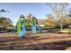 A community playground with slides, climbing structures, and seating areas in a secure, fenced environment at 4706 Cayo Costa Pl, Bradenton, FL 34203