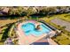 A beautifully landscaped community pool with ample lounge seating and a center island with palm trees at 4706 Cayo Costa Pl, Bradenton, FL 34203