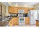 Modern kitchen featuring wood cabinets, granite counters, and stainless steel appliances at 4731 Winslow Beacon # 12, Sarasota, FL 34235
