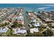 Aerial view showcasing a community with waterfront properties, canals, and beautiful coastal landscape at 500 Halyard Ln, Longboat Key, FL 34228