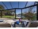 Relaxing backyard screened lanai area with views of the canal waterway and surrounding landscaping at 500 Halyard Ln, Longboat Key, FL 34228