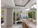 Bathroom featuring a double sink vanity, mirrors and sliding glass doors to private outdoor space at 500 Halyard Ln, Longboat Key, FL 34228