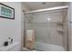 Tiled shower and tub combination featuring a glass enclosure and neutral finishes at 500 Halyard Ln, Longboat Key, FL 34228