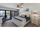 Main bedroom featuring a water view, ceiling fan, and access to the outdoor patio at 500 Halyard Ln, Longboat Key, FL 34228