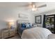 Nautical themed bedroom with a white ceiling fan, blue accents and outdoor access at 500 Halyard Ln, Longboat Key, FL 34228