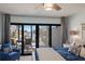 Main bedroom featuring a ceiling fan, and access to the outdoor patio overlooking the water at 500 Halyard Ln, Longboat Key, FL 34228