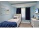 Cozy blue bedroom with nautical decor, a single bed, and a window view at 500 Halyard Ln, Longboat Key, FL 34228
