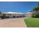 Beautiful waterfront home with a circular driveway, well-manicured lawn, and lush landscaping at 500 Halyard Ln, Longboat Key, FL 34228