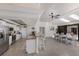 Open kitchen and dining area with stainless steel appliances, granite countertops, and ample natural light from skylights at 500 Halyard Ln, Longboat Key, FL 34228