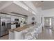 Bright kitchen featuring white cabinetry, granite countertops, stainless steel appliances and eat-in bar at 500 Halyard Ln, Longboat Key, FL 34228