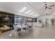 Open living room with lots of natural light, tile floors, dining area, and access to screened pool at 500 Halyard Ln, Longboat Key, FL 34228