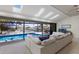 Living room with skylights, view of screened pool, waterway, and comfortable seating at 500 Halyard Ln, Longboat Key, FL 34228