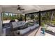 Comfortable covered patio with plush seating and views of landscaped backyard and serene surroundings at 500 Halyard Ln, Longboat Key, FL 34228