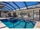 Inviting pool features a spa, covered lanai, and views of the living room, kitchen, and waterfront at 500 Halyard Ln, Longboat Key, FL 34228