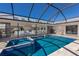 Beautiful enclosed pool area with an in-ground spa and views of the home's interior and design at 500 Halyard Ln, Longboat Key, FL 34228
