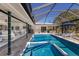Screened pool and spa with seamless access to the home's open-concept living and dining areas at 500 Halyard Ln, Longboat Key, FL 34228