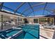 Screened pool and spa with seamless access to the home's open-concept living and dining areas at 500 Halyard Ln, Longboat Key, FL 34228