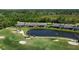 Aerial view of the homes with the pond, golf course, and the surrounding community at 5223 Chase Oaks Dr, Sarasota, FL 34241